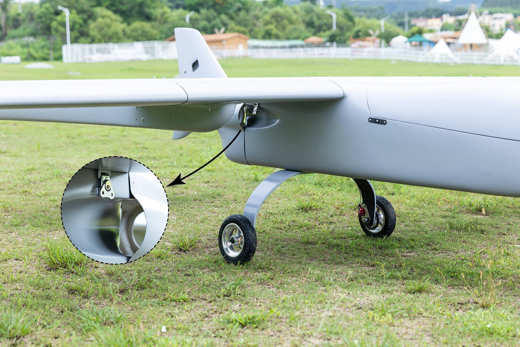 Skyeye Carbon fiber 6000mm UAV Fixed Wing Drone on grass field showing detail of disc brake system.