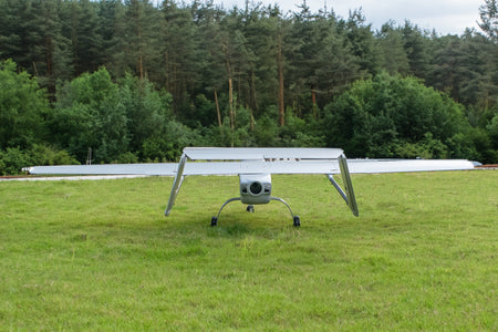 Skyeye 4500mm UAV Fixed Wing Drone on carbon fiber with forest background.