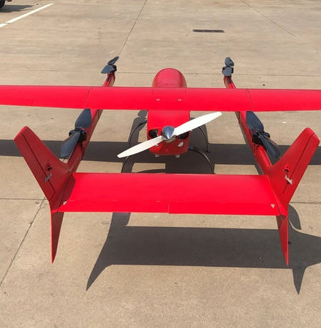 Industrial red VTOL drone with 6000mm wingspan on a concrete surface.