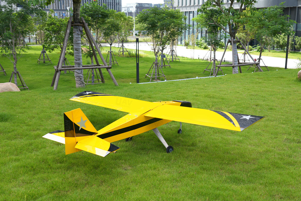 Skyeye 50cc practice drone flying UAV Fixed Wing in a green outdoor setting.